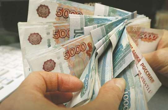 An employee counts rouble banknotes at a shop selling home appliances in Krasnoyarsk, Russia. Led by a plunge of more than 7% in Russiau2019s currency, Kazakhstanu2019s tenge and the Belarusian rouble are among the worldu2019s 12 worst performers this month against the dollar, followed closely by Georgiau2019s lari.