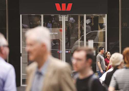 People walk past a Westpac bank branch in Sydney. Westpac this month moved to tighten living expense assessments of new home loan customers, in order to make sure they could afford to service the debt. From April 17, it is also requesting online banking details of potential borrowers, to check their income and spending habits.