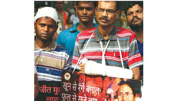 Victims of violence in the run-up to the panchayat polls in West Bengal stage a demonstration outside the residence of federal Home Minister Rajnath Singh, in New Delhi yesterday.