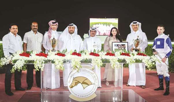 Qatar Racing and Equestrian Club (QREC) deputy chief steward Abdulla al-Kubaisi with the winners of Al Karana Cup after Khalifa bin Sheail al-Kuwariu2019s Acrobate won the mile-long race at the QREC yesterday. PICTURE: Juhaim