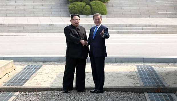 South Korea's President Moon Jae-in (right) and North Korea's leader Kim Jong Un shake hands ahead of the inter-Korean summit in Panmunjom on Friday.