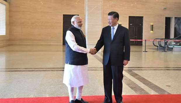 India's Prime Minister Narendra Modi shaking hands with Chinese President Xi Jinping in Wuhan on Friday.