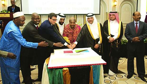 Tanzaniau2019s ambassador Fatma Mohamed Rajab is joined by Qataru2019s Minister for Development Planning and Statistics HE Dr Saleh Mohamed Salem al-Nabit, Ministry of Foreign Affairs protocol chief Ibrahim Fakhro and other dignitaries in cutting a cake on the occasion of the 54th anniversary of the Union Day of Tanzania on Thursday in Doha. PICTURE: Nasar T K.