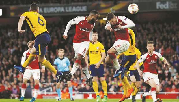 Arsenalu2019s Alexandre Lacazette (centre) and Aaron Ramsey in action during the Europa League semi-final first leg match against Atletico Madrid at the Emirates Stadium in London on Tuesday night. (Reuters)