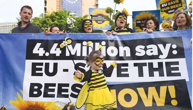 Activists stage a demonstration yesterday to call upon European member states to protect the bees by voting a full ban on bee-killing pesticides, in front of the European Commission in Brussels.