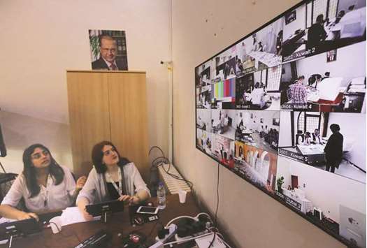 Members of Lebanonu2019s electoral commission monitor screens bearing images of embassies around the Middle East at the Ministry of Foreign Affairs in Beirut, to check the electoral process as Lebanese expats start voting in the parliamentary elections, yesterday.