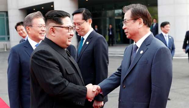 North Korean leader Kim Jong Un shakes hands with Suh-hoon, South Korea's chief of the National Intelligence Service (NIS) at the truce village of Panmunjom