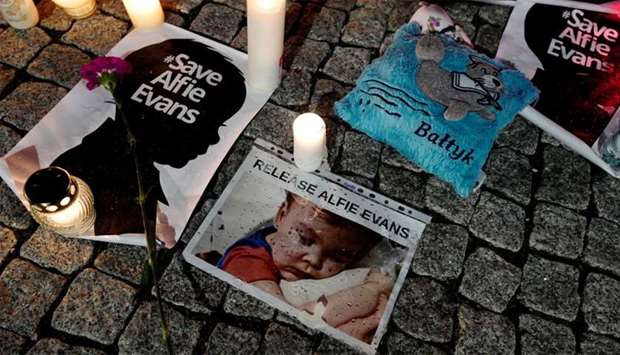 Candles and placards are pictured during a protest in support of Alfie Evans, in front of the British Embassy building in Warsaw
