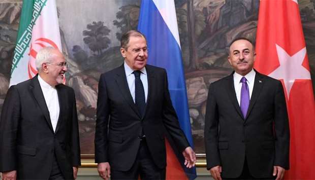 Russian Foreign Minister Sergei Lavrov (C), his Turkish counterpart Mevlut Cavusoglu (R) and Iran's Foreign Minister Mohammad Javad Zarif