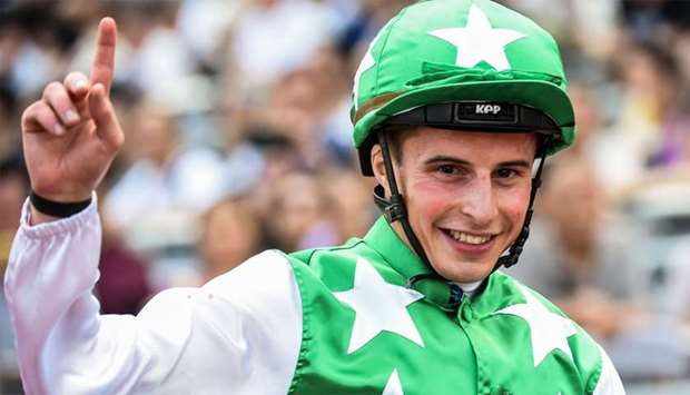 Jockey William Buick of Norway onboard 'Pakistan Star' gestures after winning the QEII Cup horse race