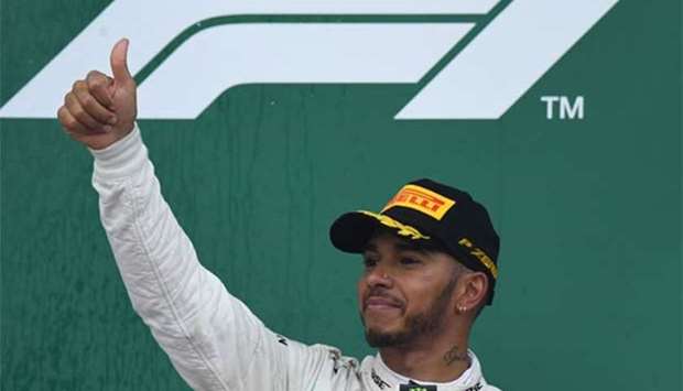 Mercedes' British driver Lewis Hamilton celebrates on the podium in Baku on Sunday.