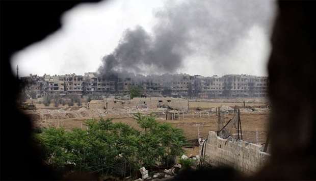 Smoke rising from buildings in Yarmuk, Syria