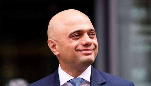 Sajid Javid stands outside the Home Office after being named as Britain's Home Secretary, in London on Monday