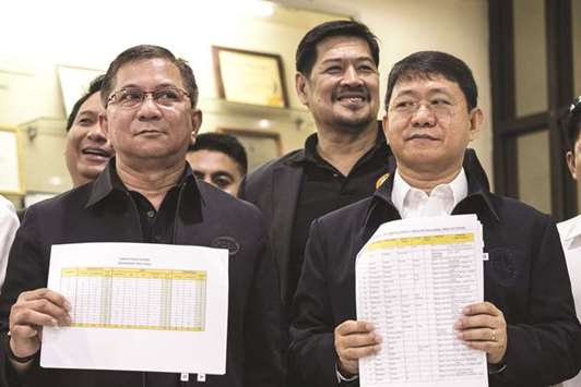 Philippine Drug Enforcement Agency (PDEA) Director Aaron Aquino (left) and Department of Interior and Local Government (DILG) Secretary Eduardo Ano (right) hold lists of alleged politicians involved in drugs at the PDEA headquarters in Manila, yesterday.