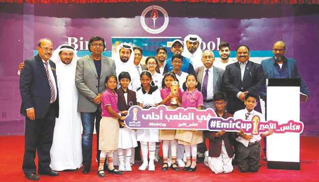 QFA and Birla Public School officials pose with schoolchildren and the Amir Cup trophy during the Amir Cup Trophy Tour.
