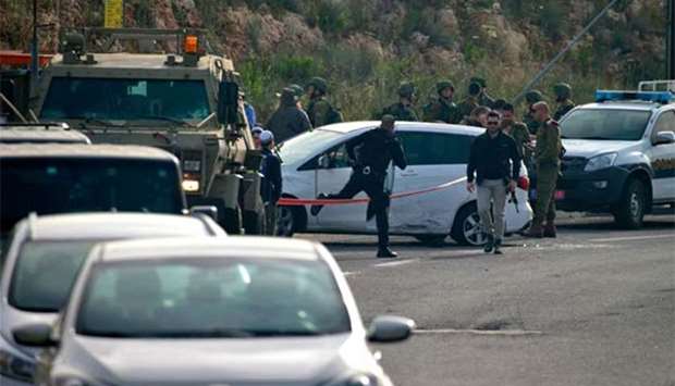 Israeli policemen cordon off the site where an Arab Israeli man was shot dead by soldiers near Ariel, south of the Palestinian city of Nablus, on Tuesday.