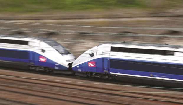 A TGV high-speed train passes by a SNCF depot station in Charenton-le-Pont near Paris. French rail unions began late last night a three-month rolling strike u2013 two days out of every five u2013 at state operator SNCF against planned reforms.