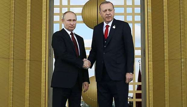 Turkish President Tayyip Erdogan (R) shakinghands with his Russian counterpart Vladimir Putin (L) during a welcoming ceremony at the start of Putin's visit to Turkey at the Presidential Palace in Ankara.