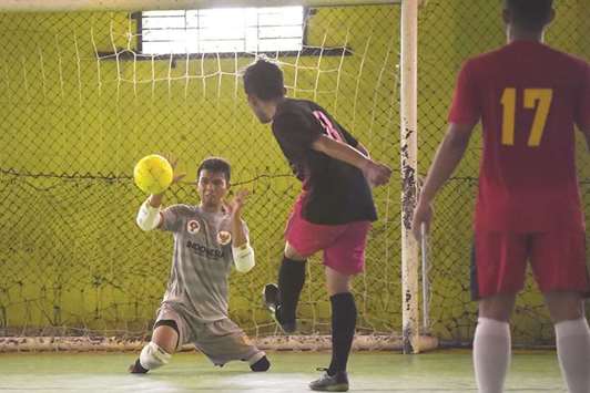 In this February 3, 2018, picture, Eman Sulaeman (left) attempts a save during a futsal match in Indramayu, West Java. (AFP)