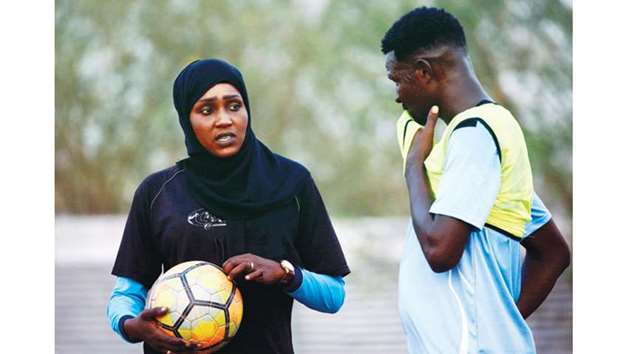 In this February 17, 2018, picture, Salma al-Majidi (left), acknowledged by FIFA as the first Arab and Sudanese woman to coach a menu2019s team in the Arab world, instructs an Al-Ahly Al-Gadaref club player during a training session in Gedaref, Sudan. (AFP)