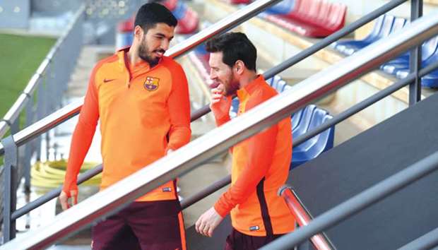 Barcelonau2019s Lionel Messi and Luis Suarez arrive for a training session in Barcelona, Spain, yesterday. (Reuters)