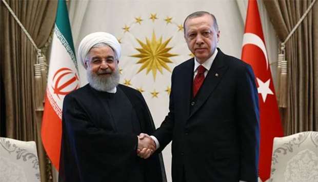 Iranian President Hassan Rouhani shakes hand with Turkish President Recep Tayyip Erdogan in Ankara on Wednesday.