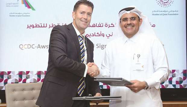 QCDC director Abdulla al-Mansoori (right) and Awsaj Academy director Dr Donald Francis during the MoU signing yesterday.