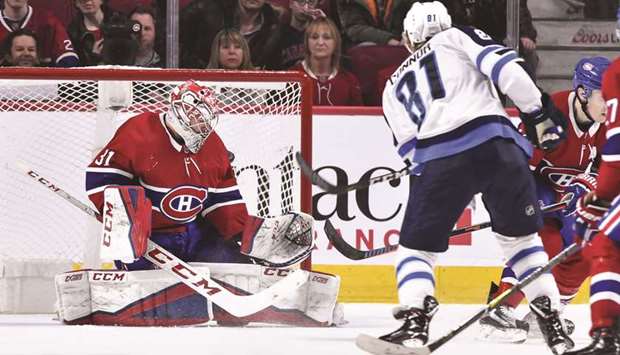 Kyle Connor of the Winnipeg Jets gets the puck past goaltender Carey Price of the Montreal Canadiens in overtime during their NHL game at the Bell Centre in Montreal. (Getty Images/AFP)