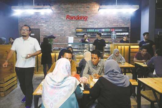 People eat at chicken rendang restaurant in Cyberjaya, Selangor, Malaysia.
