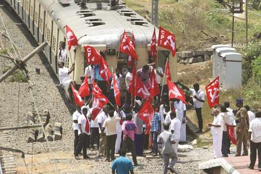 Communist Party of India activists block a train as they protest over the Cauvery issue in Chennai yesterday.