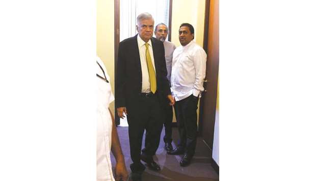 Sri Lankan Prime Minister Ranil Wickremesinghe, centre, leaves his office in parliament before the debate of no-confidence against him, in Colombo yesterday.