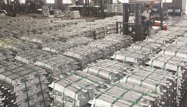 A worker drives a forklift to transport aluminium bars at a factory in Anshun, China (file). Aluminium futures fell as much as 1% in Shanghai yesterday, while they rose on the London Metal Exchange.