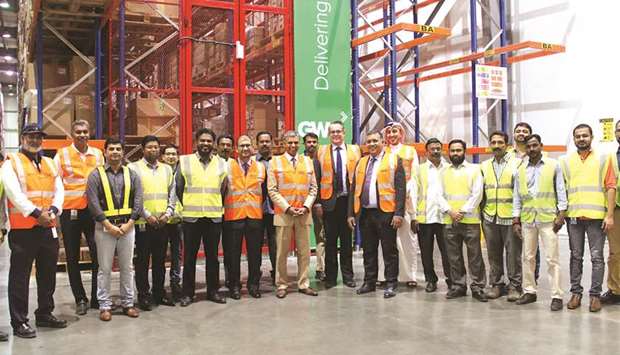 Kumaran, Bhagat, Phelps with GWC employees at the Logistics Village Qatar yesterday.