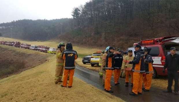 Rescue personnel gather near the scene of an F-15K fighter jet crash in southeastern South Korea on Thursday.