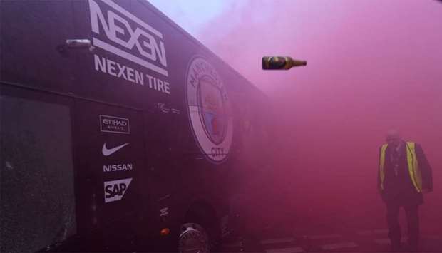 Bottles and cans are thrown at the bus as Manchester City players arrive at the stadium before the UEFA Champions League first leg quarter-final football match between Liverpool and Manchester City