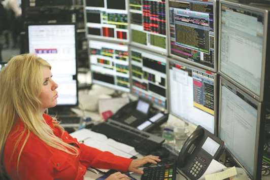 A trader is seen at the London Stock Exchange. The FTSE 100 climbed 2.4% to 7,199.50 yesterday, with telecom shares climbing after strong bidding for frequencies for the next generation of mobile phone technology.