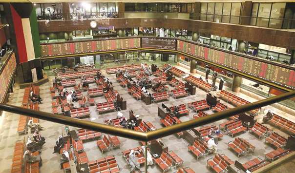 Kuwaiti traders follow the stock market at the Kuwait Stock Exchangein Kuwait City (file). The Gulf nation this week activated the latest round of a market shake-up aimed at attracting investors and initial public offerings.