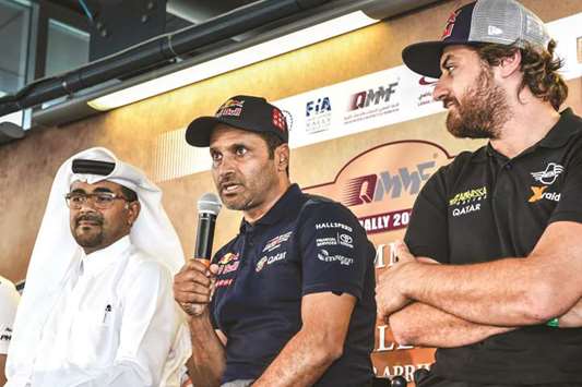QMMF President Abdulrahman al-Mannai (left) with Qatari driver Nasser Saleh al-Attiyah (centre) and rider Mohamed Abu Issa.