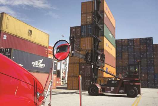 The windshield of a truck reflects in a side mirror as a top loader prepares to move a shipping container at the Port of Savannah in Georgia, US (file). The Commerce Department yesterday said the trade gap increased 1.6% to $57.6bn in February, the highest level since October 2008.