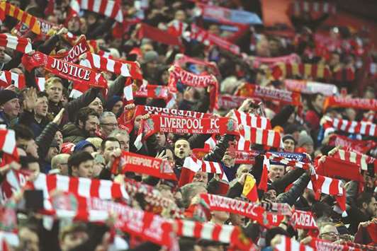 Liverpool supporters cheer during the UEFA Champions League first leg  quarter-final match against Manchester City at Anfield stadium in Liverpool on Monday.