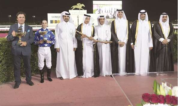 Sheikh Khalifa bin Mohamed bin Khalifa al-Thani (fourth from left) and Al Shahania Stud director Abdul Rahman al-Mansour (fourth from right) hold the Qatar Gold Sword in the presence of His Excellency Sheikh Thani bin Hamad bin Khalifa al-Thani (third from right), Qatar Racing and Equestrian Club (QREC) Board member Abdullah al-Sheikh al-Kuwari (second from right) and QREC general manager Nasser Sherida al-Kaabi (right) after Julian Smart-trained Gazwan won the 2000m race at the QREC yesterday.