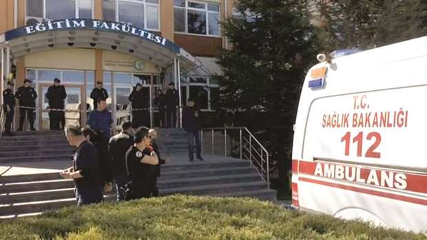 Police officers and an ambulance are seen at the entrance of Osmangazi University after the shooting.