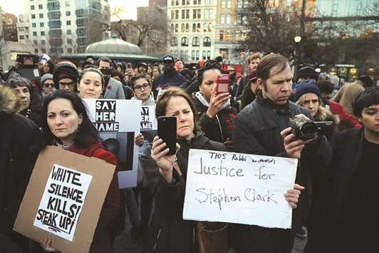 People attend a vigil for Stephon Clark, the young black man killed by police last month in Sacramento, on the anniversary of the assassination of Dr Martin Luther King in New York City on Wednesday. Tensions have flared in Sacramento and across the nation after an independent autopsy revealed that police officers shot Clark at least seven times in the back on March 18 while responding to reports of someone smashing car windows in his neighbourhood.