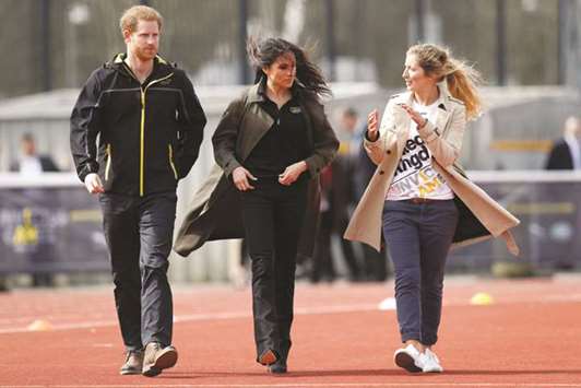 Prince Harry, patron of the Invictus Games Foundation, Meghan Markle and Jayne Kavanagh, chef de mission for the UK team, watch athletes at the team trials for the Invictus Games Sydney 2018 at the University of Bath Sports Training Village in Bath, Britain, yesterday.