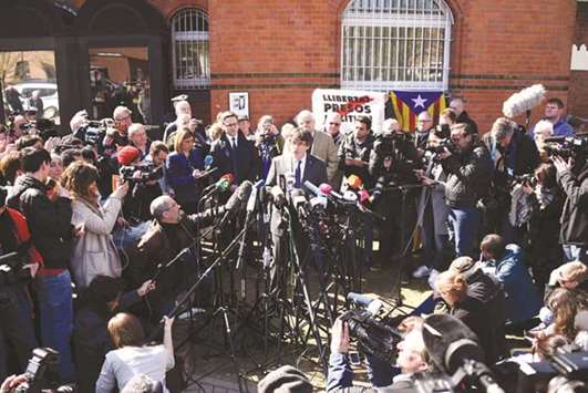 Puigdemont speaks to the media after leaving the detention centre (Justizvollzugsanstalt, JVA) in Neumuenster, northern Germany.