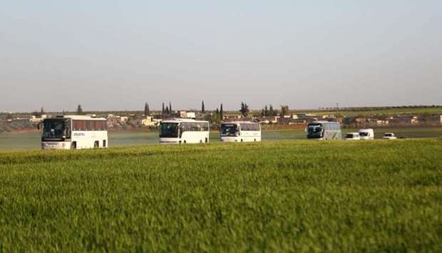 Buses carrying families from the former rebel bastion's main town of Douma