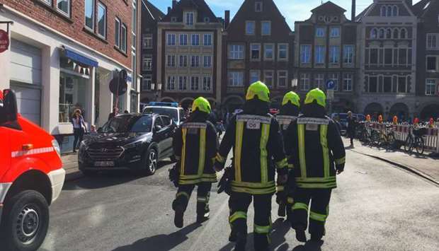 First responders work at the scene when several people were killed and injured when a car ploughed into pedestrians in Muenster, western Germany