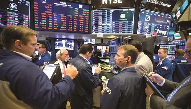 Traders work on the floor of the New York Stock Exchange (file). The rockiest US stock market in two years will meet a major test in the coming weeks as first-quarter earnings pour in, with expectations that tax cuts will help corporate America show its biggest quarterly profit growth in seven years.