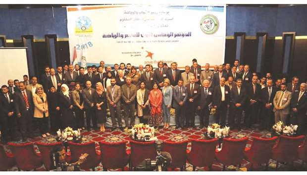 Delegates pose during a conference on sport for peace in Baghdad on April 4.