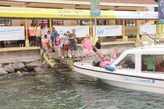 Tourists board a motor boat as they leave Boracay island in Malay town, Aklan province, central Philippines, yesterday.